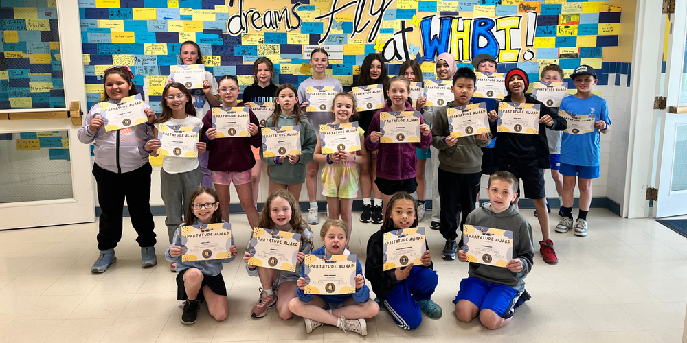 Spartatude winners stand in group with certificates.