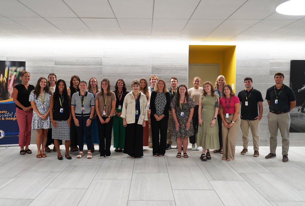 Twenty-one new Queensbury teachers stand in group at QHS.