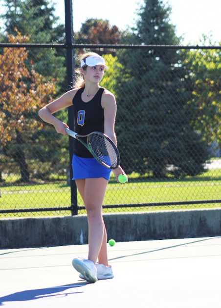 Nicole Greenstein serves the ball in tennis match.