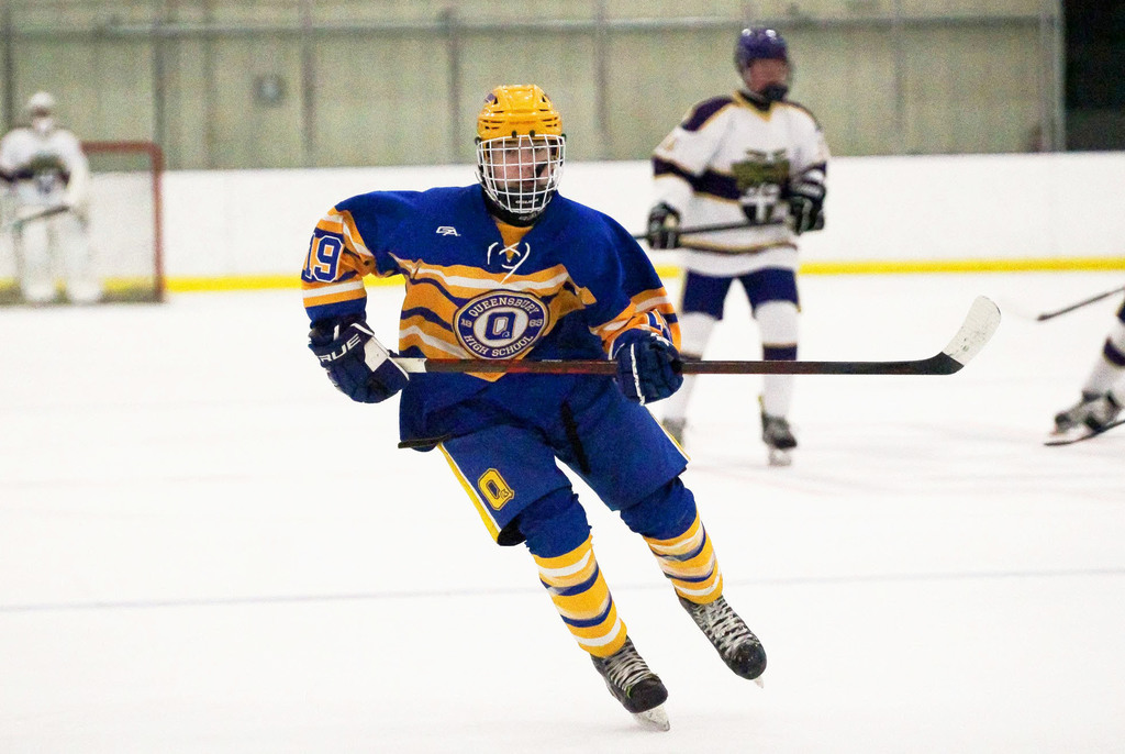 QHS hockey player on the ice.