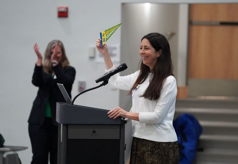 Jenny Postlethwait holds up a pennant.