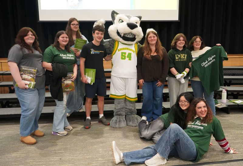 Students pose with SUNY Adirondack mascot Eddy Rondack.