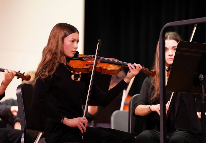 Caitlin Scott performs on violin during a school concert.