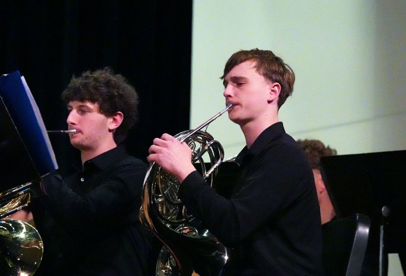 Steven Johnson plays French horn during a school concert.