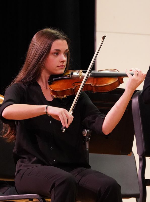 Julia Ross performs on violin during a school concert.