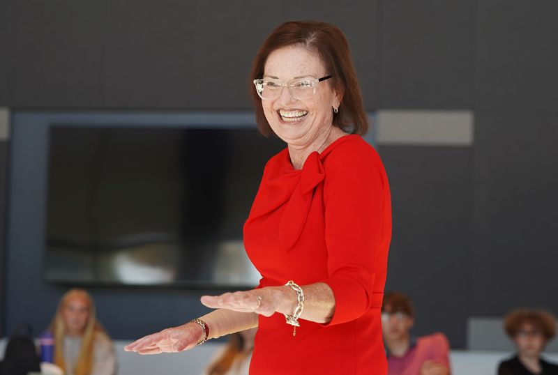 Photo of Kathleen Hogan talking to QHS students.