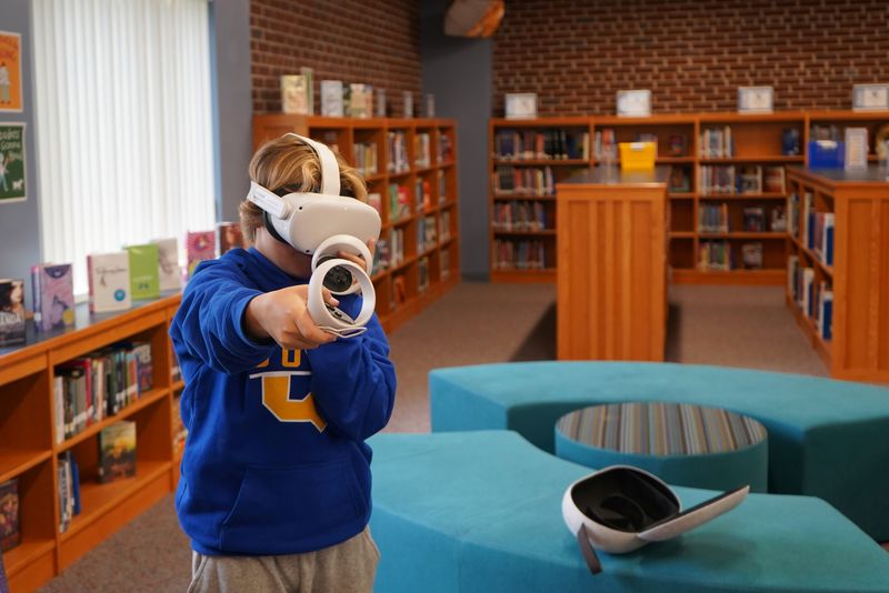 Student tries VR goggles to explore careers.
