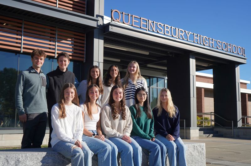 Top 10 students sit outside Queensbury High School.