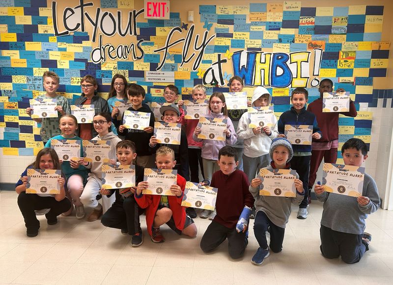 Students stand in group with certificates.
