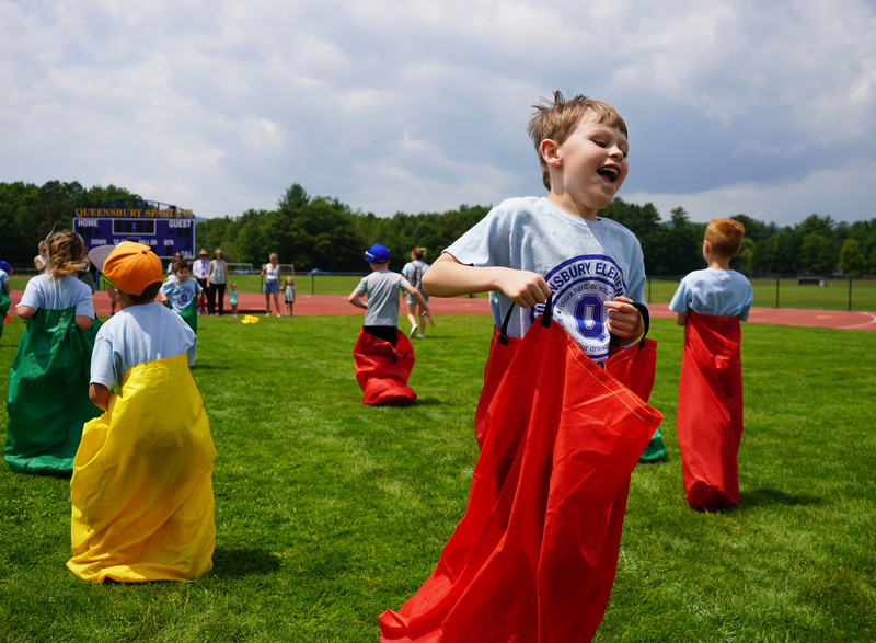 Student bounces in a potato sack race.