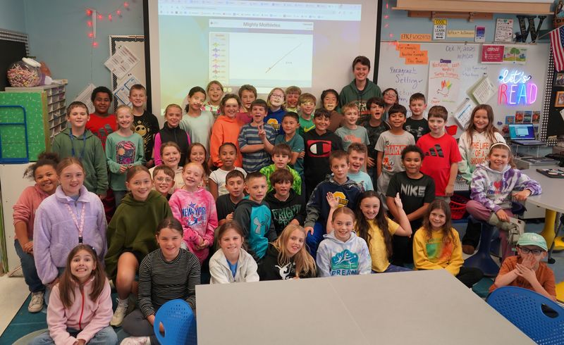 Ryan Greenstein stands with fourth graders at William H. Barton Intermediate School.