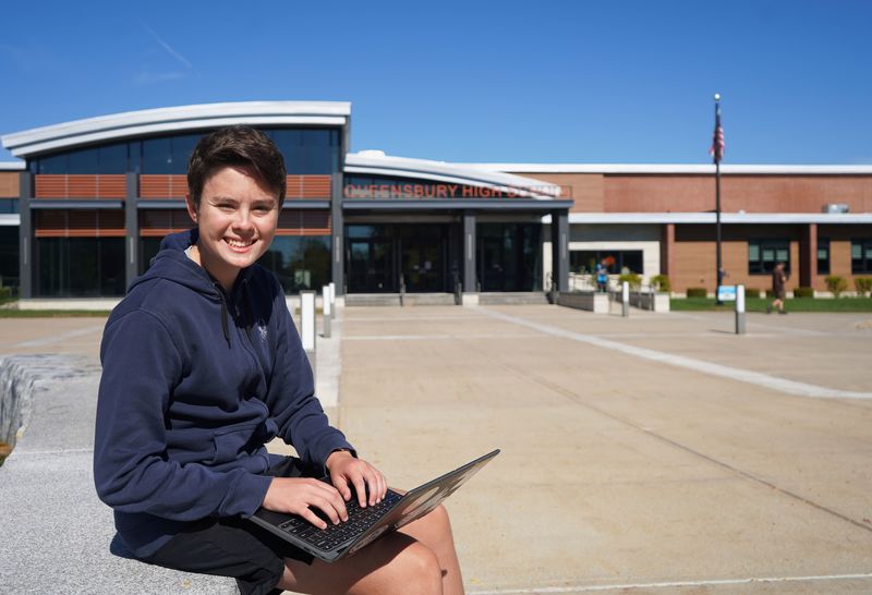 Ryan Greenstein sits outside in front of Queensbury High School.