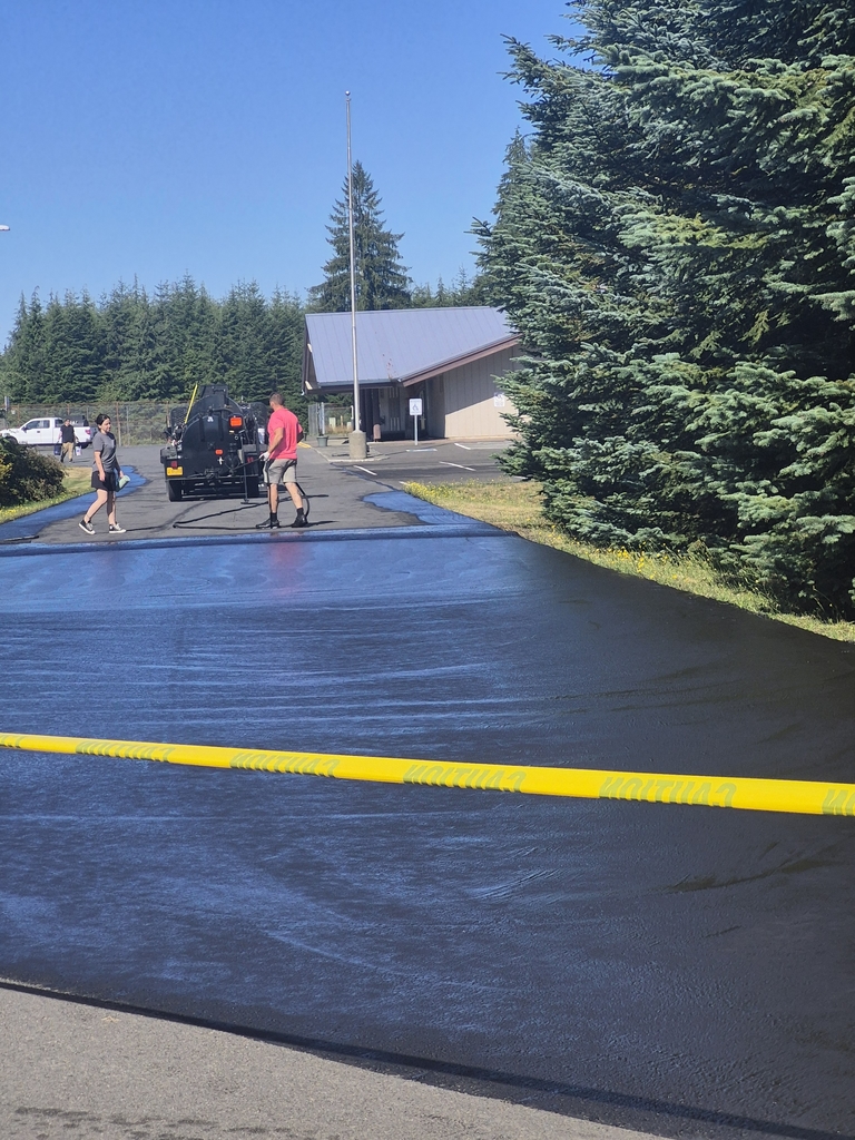 parking lot entrance being revealed by two workers.