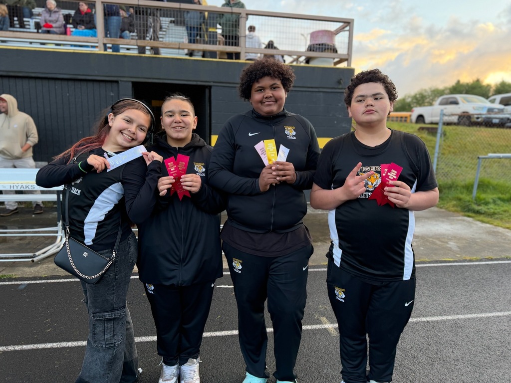 Track athletes holding their ribbons. 