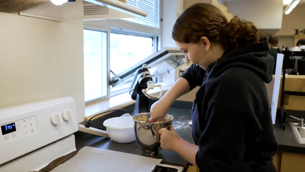 Student baking cookies