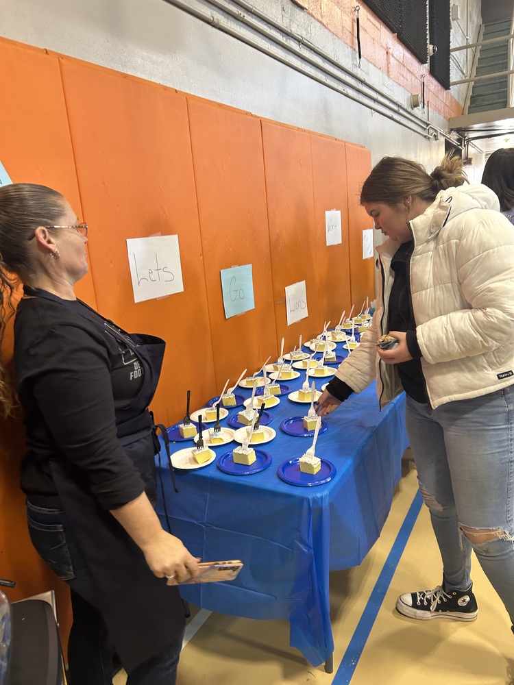 Student choosing a piece of Lions ' cake!