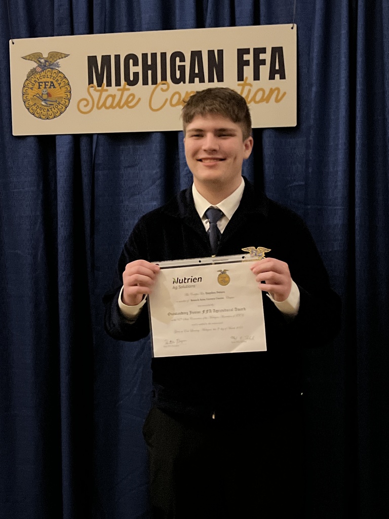 student holding certificate