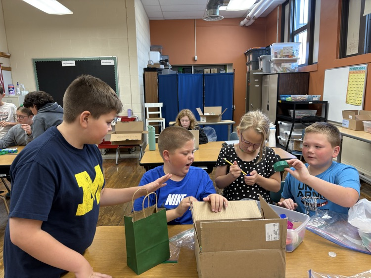 5th graders cleaning plastic lids for our bench project.