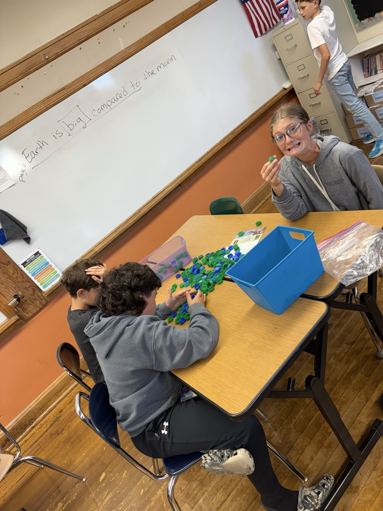 5th graders cleaning plastic lids for our bench project.