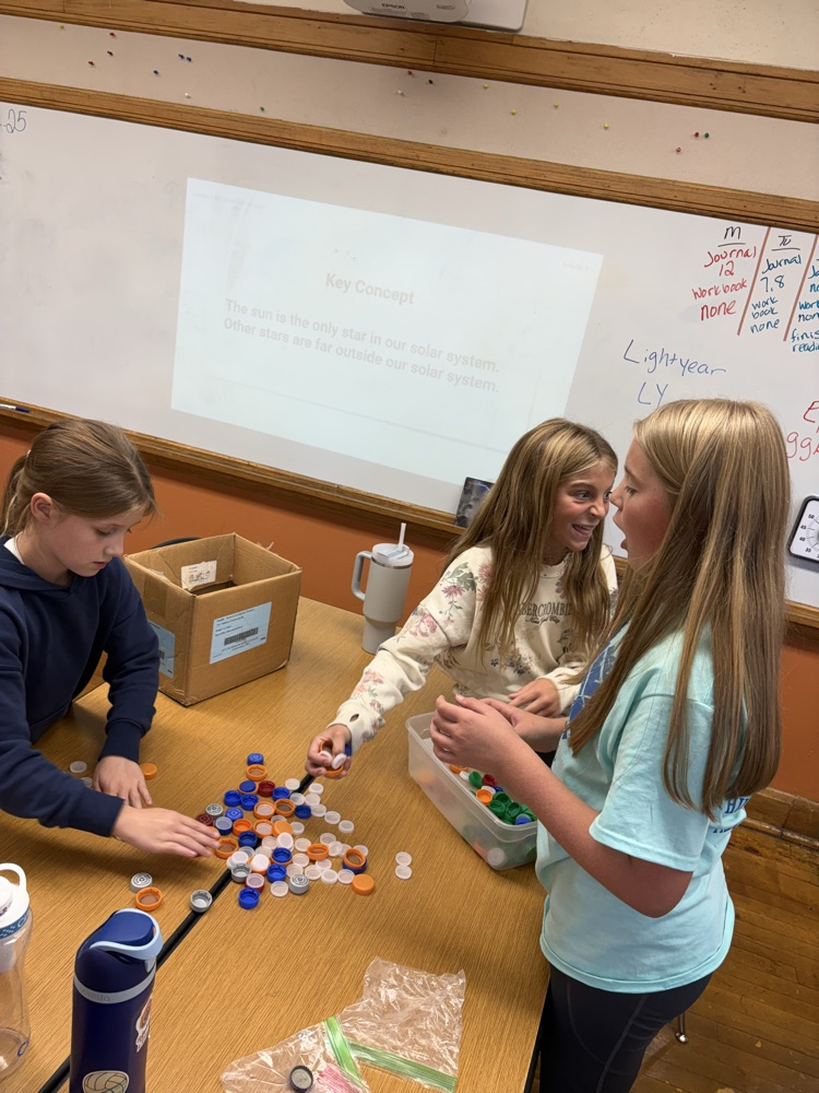 5th graders cleaning plastic lids for our bench project.