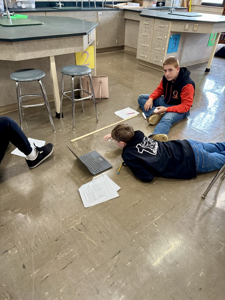 Students investigating force, mass, and velocity.