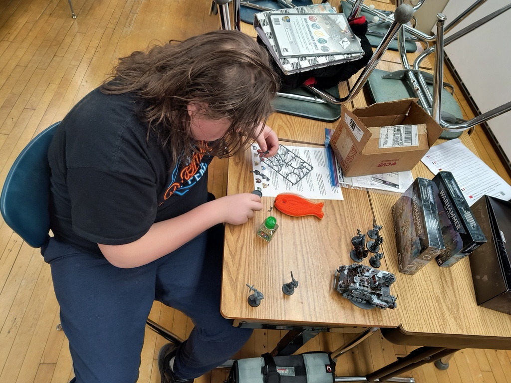 Student working on Warhammer model in Warhammer Club.