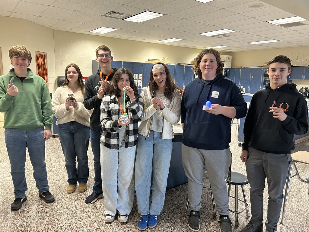 Students holding different projects from their trip at Trine.