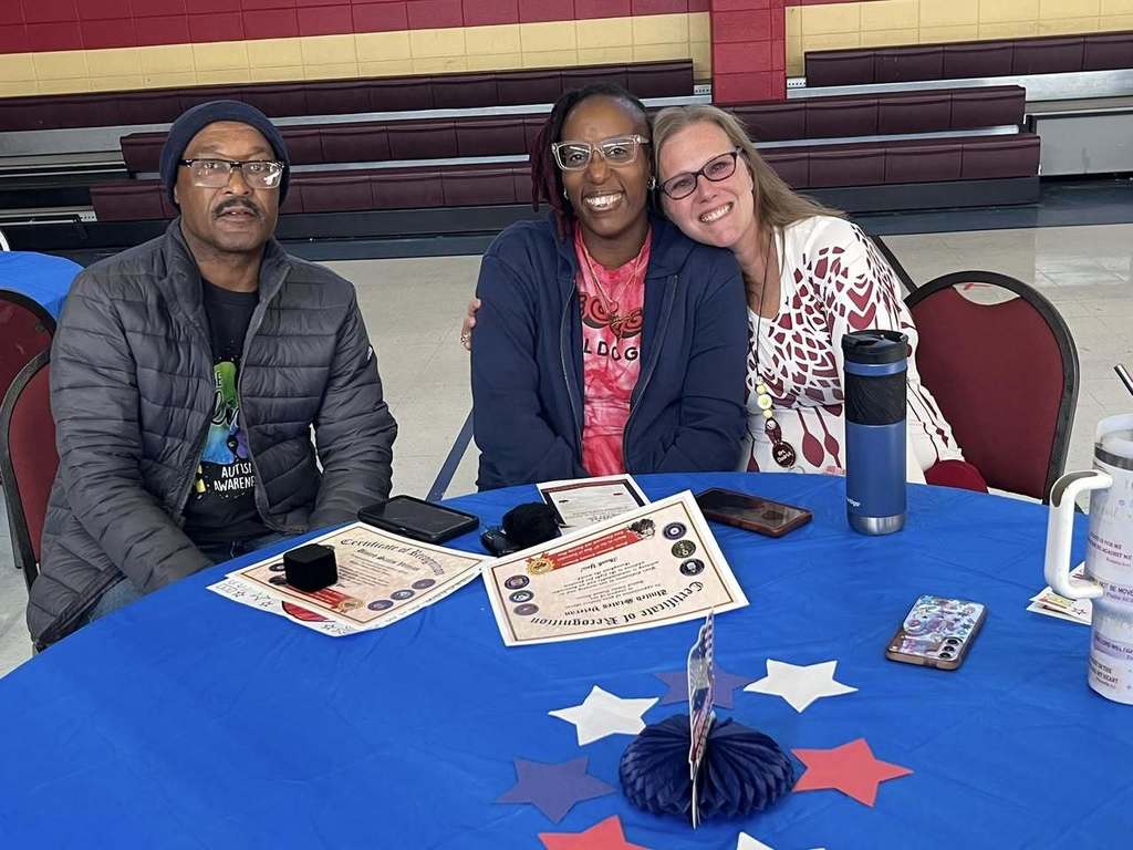 group of adults smiling for group photo