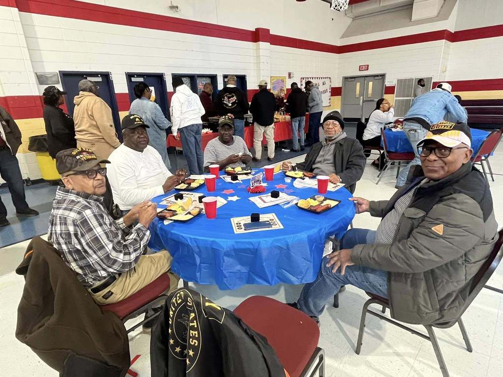 group of adults smiling for group photo
