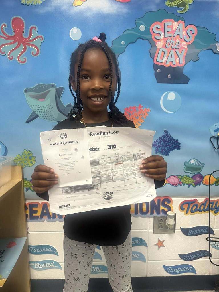 student holding award for reading 