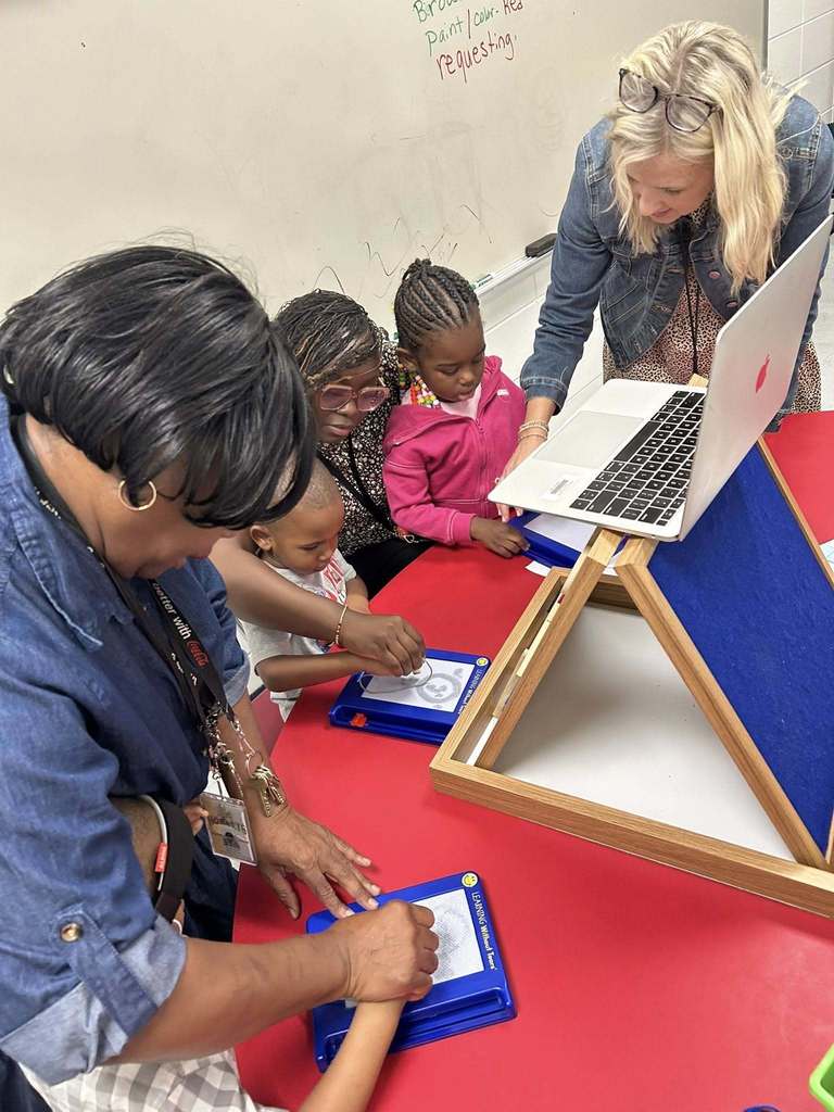 Teacher and student working on a project together at table