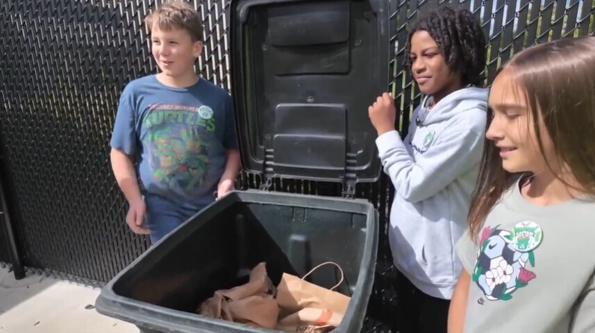 Starbuck students with the school's compost bin.