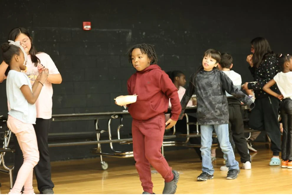 Kid walking across stage with food
