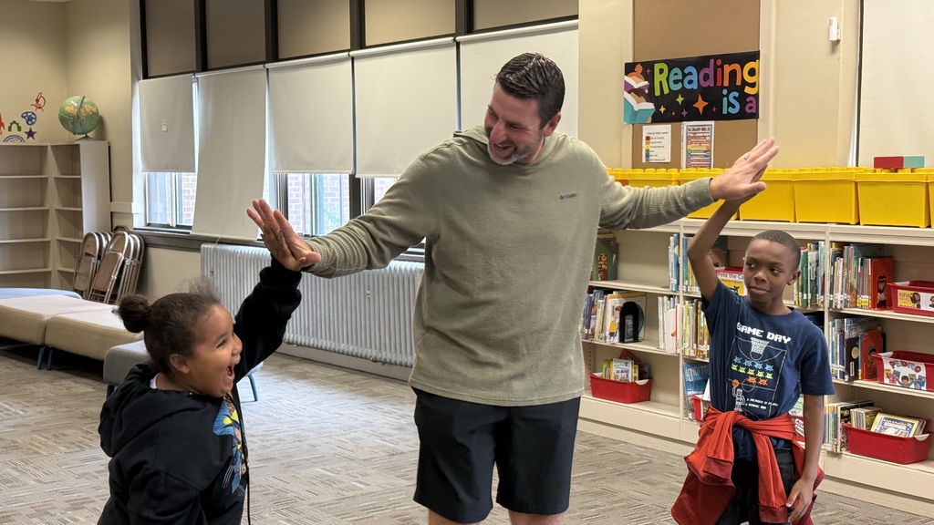 Marcus Hanel giving two students high fives