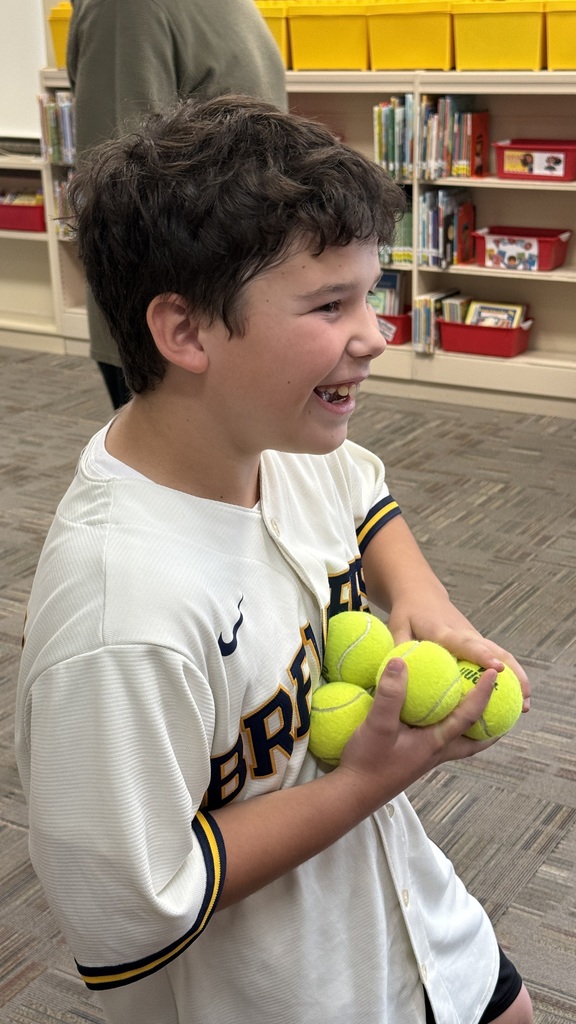 A student attempting to hold seven baseballs with one hand