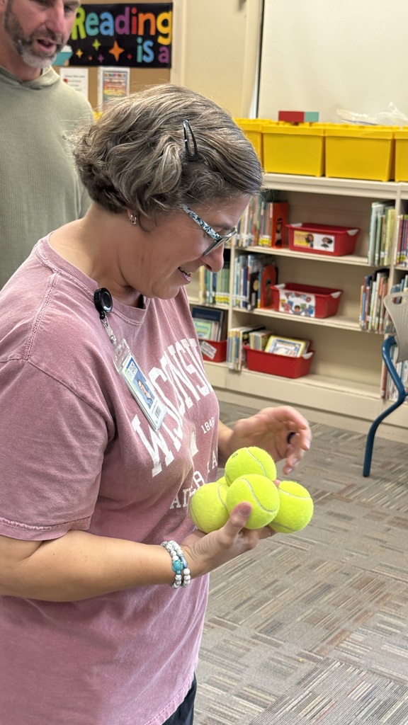 A teacher attempting to hold seven baseballs with one hand