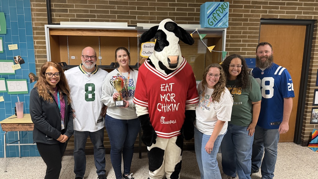 Gifford 7th graders win reading challenge (Gifford staff members and the cow)