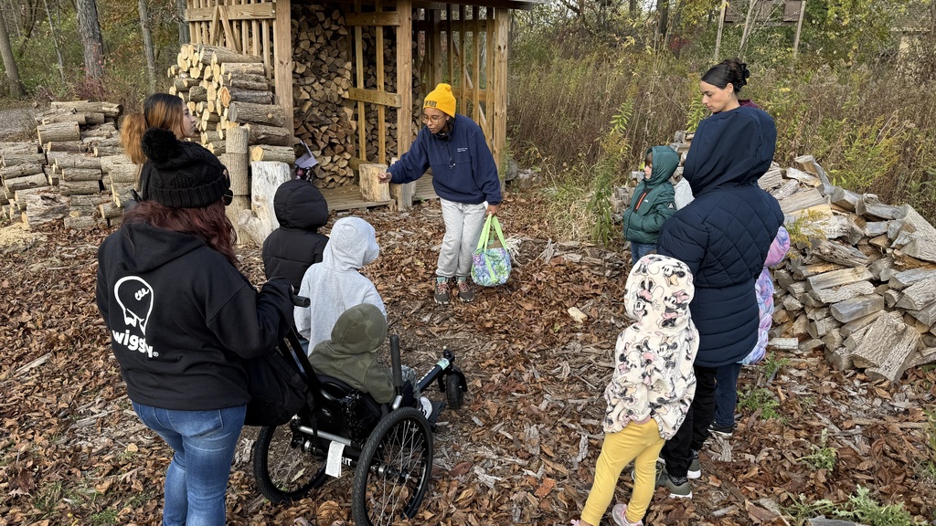 A small group of students, learning about nature from a Riverbend Nature Center guide.