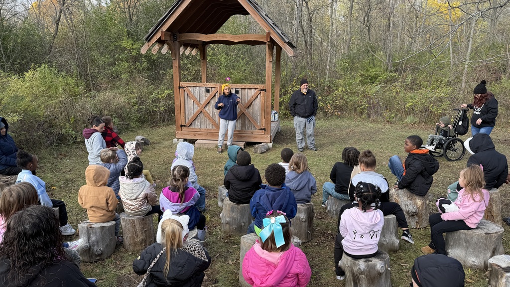 Two Riverbend Nature Center employees giving students a lesson.