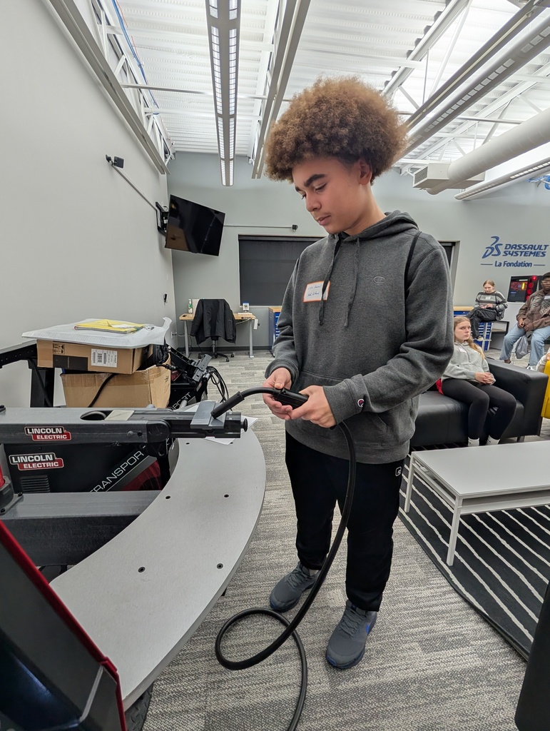 A student practicing with a welding simulator.