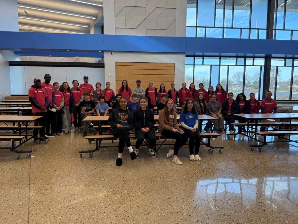 The group of about twenty college athletes that visited Schulte School with about ten students from the school.