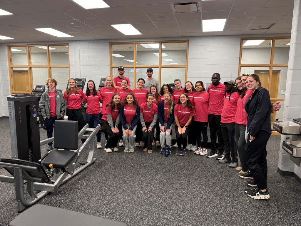 The group of about twenty college athletes that visited Schulte School.