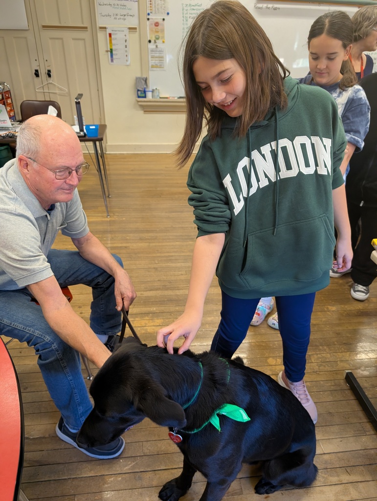 A female students pets Pepper's neck.