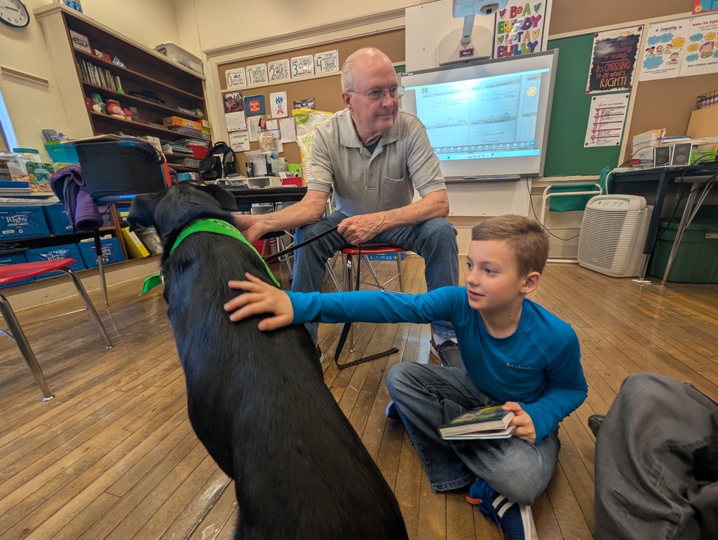 A male student pets Pepper's back.