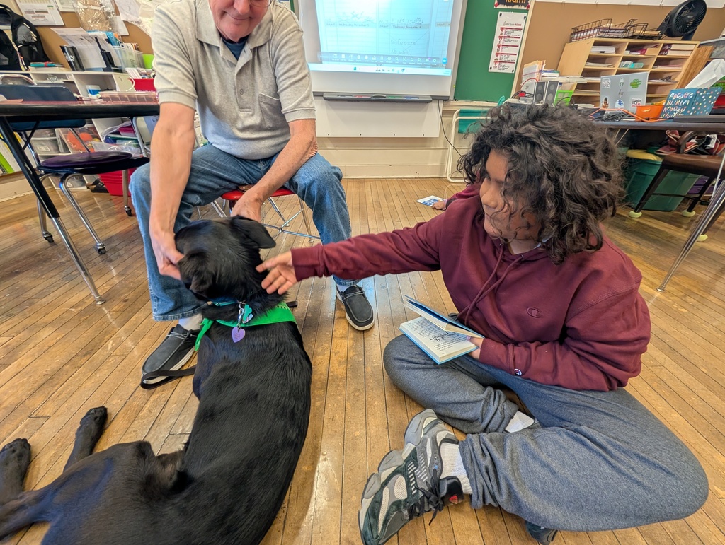 A male student pets Pepper's neck.