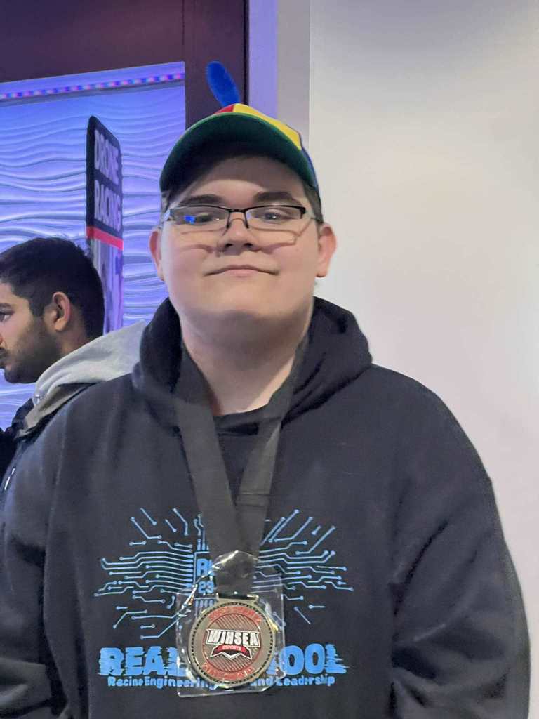 A REAL School player with his medallion.