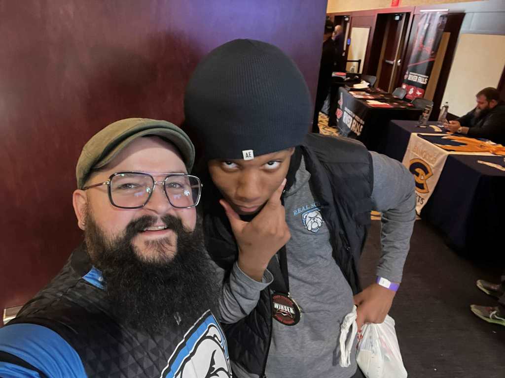 A REAL School coach and a player pose for a selfie photo.