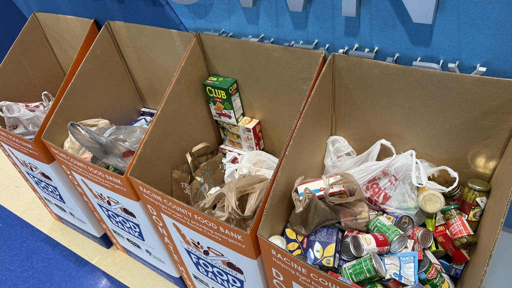 Four tall boxes filled with collected food donations.