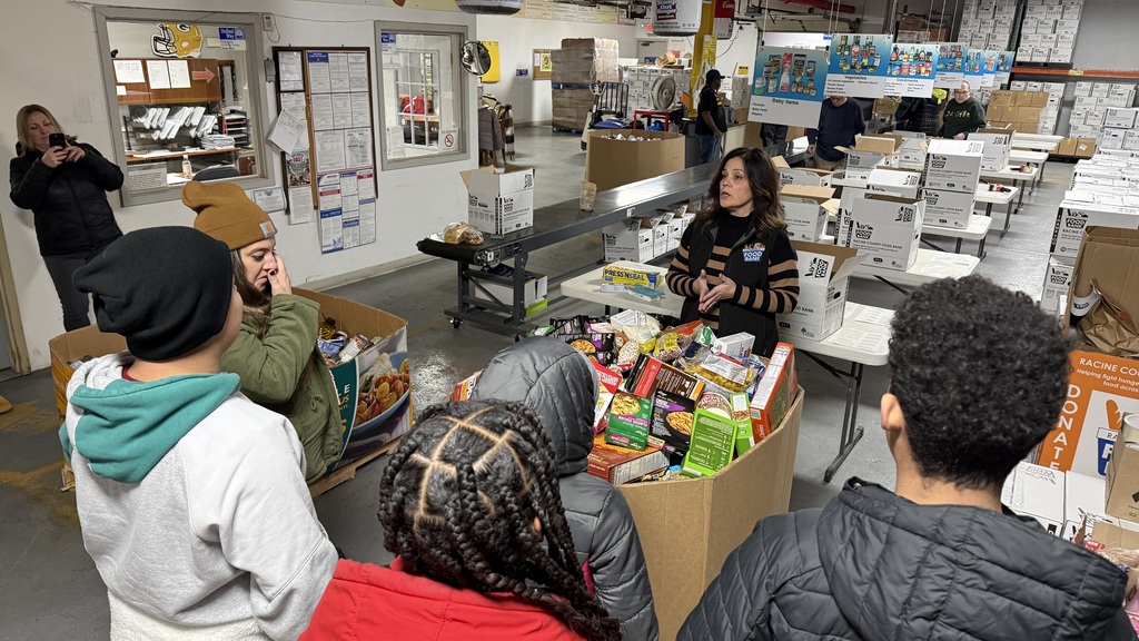 A representative of the Racine County Food Bank thanks the students for their donations.