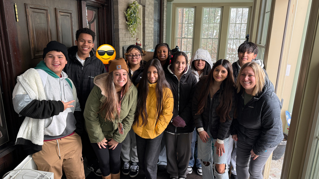 Mitchell students posing for a group photo during their donation drop off at the Women's Resource Center.